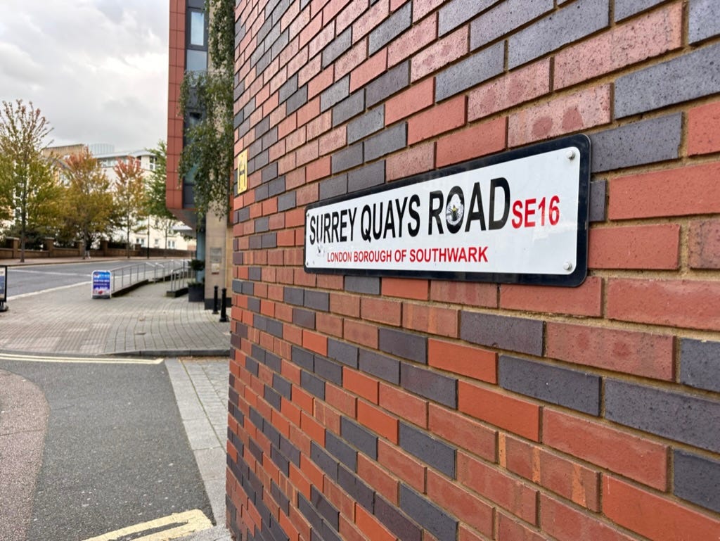 A street sign with Surrey Quays Road on it