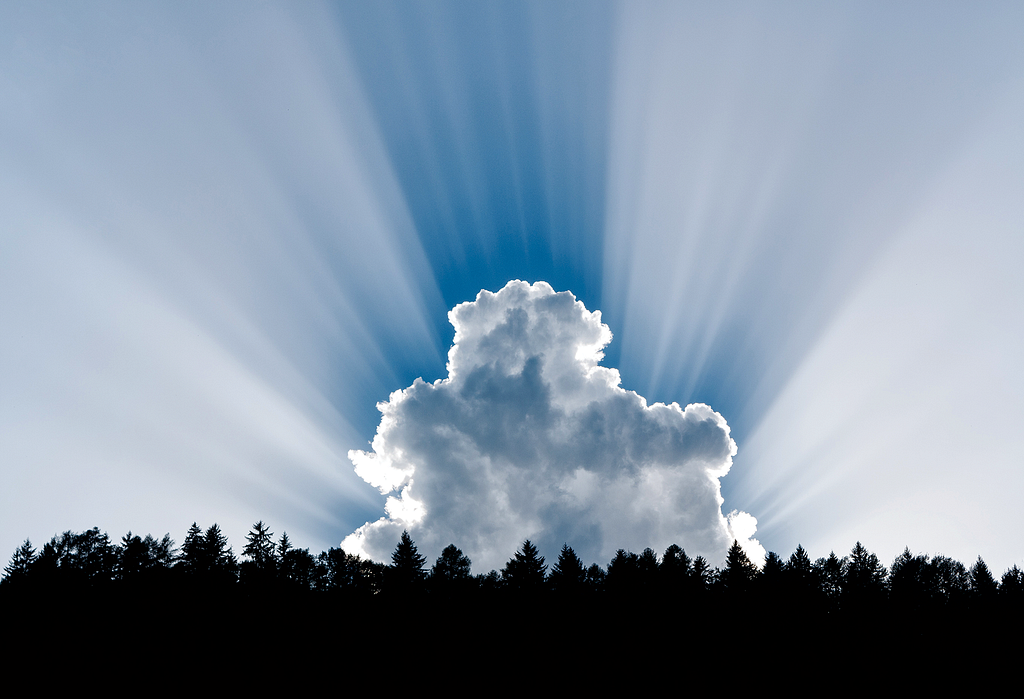 Photo of a cloud with sun rays.