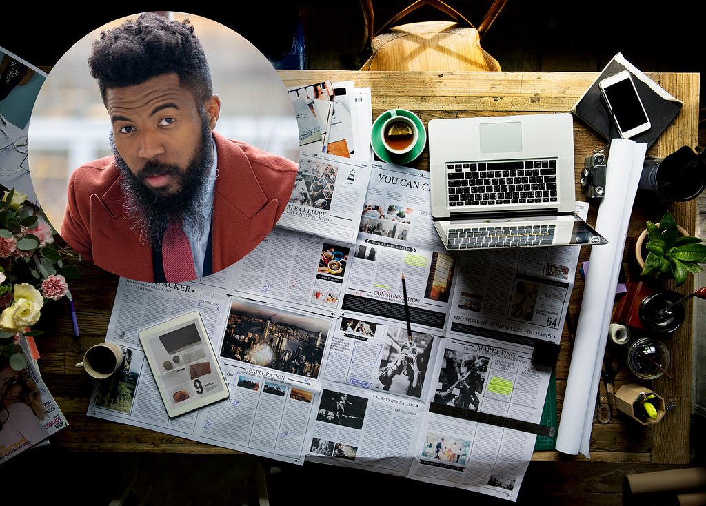 Newspapers, a laptop, a cellphone, and a vase of flowers on a table, with a circular headshot of Joshua Bennett on the upper left corner.