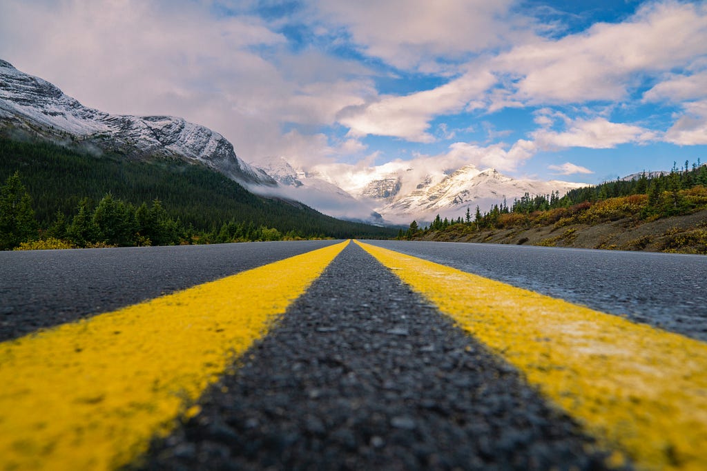 Picture of an open road with the camera positioned in the middle of the road.