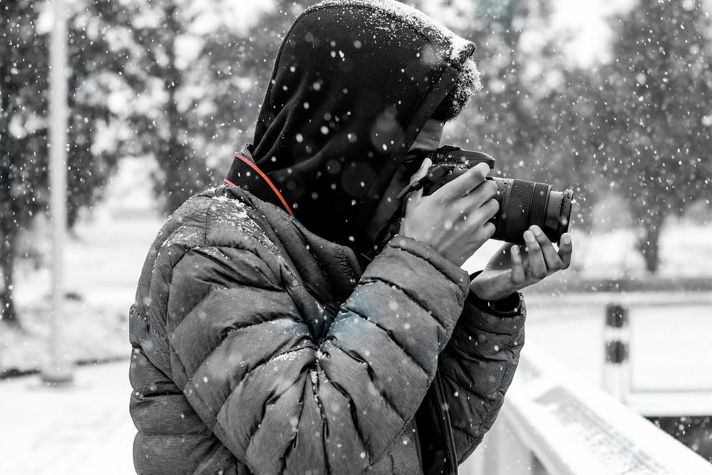 Photo of a photographer taking a photo in the snow.