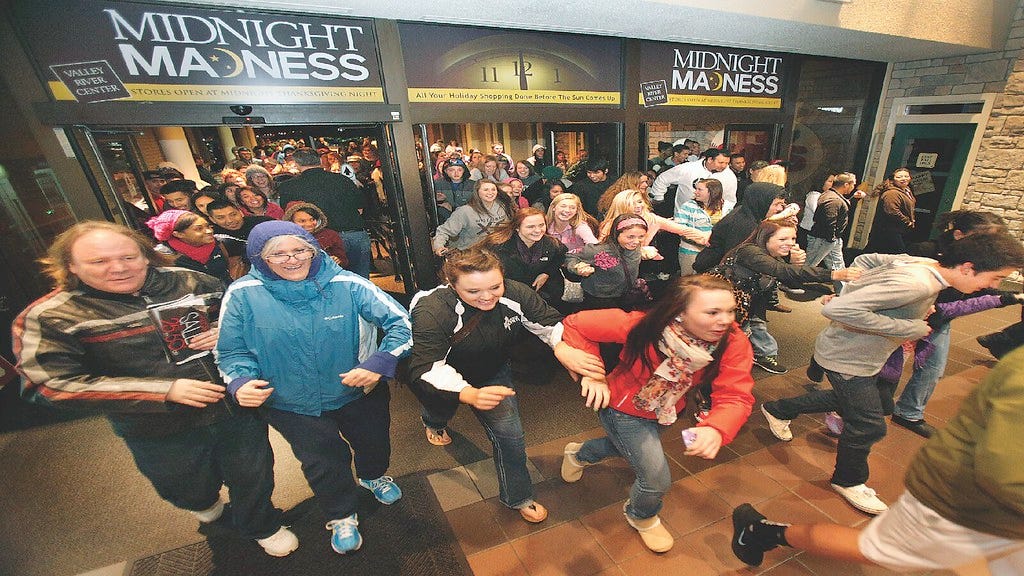 Customers rushing into a retail store during Black Friday