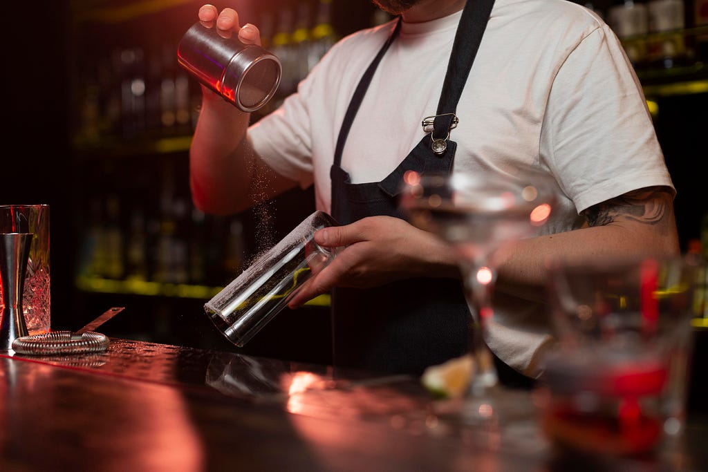 Male bartender making cocktails