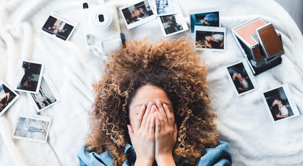 Girl surrounded by photographs