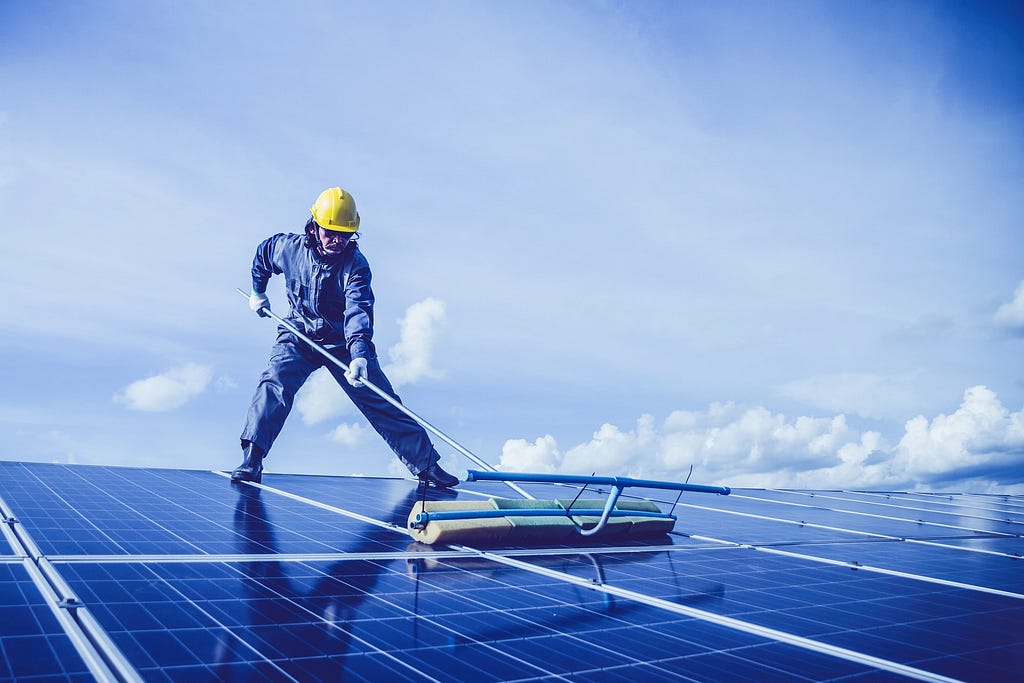 An image of a man maintenaning solar panels — Rhinobay Energy