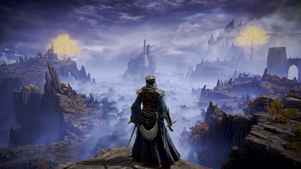 An image showing the gameplay from Elden Ring. A character can be seen standing atop a cliff, overlooking a vast and mystical landscape.