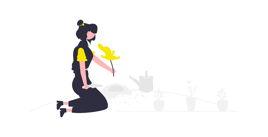 A woman kneels to smell a flower, with a watering can by her side