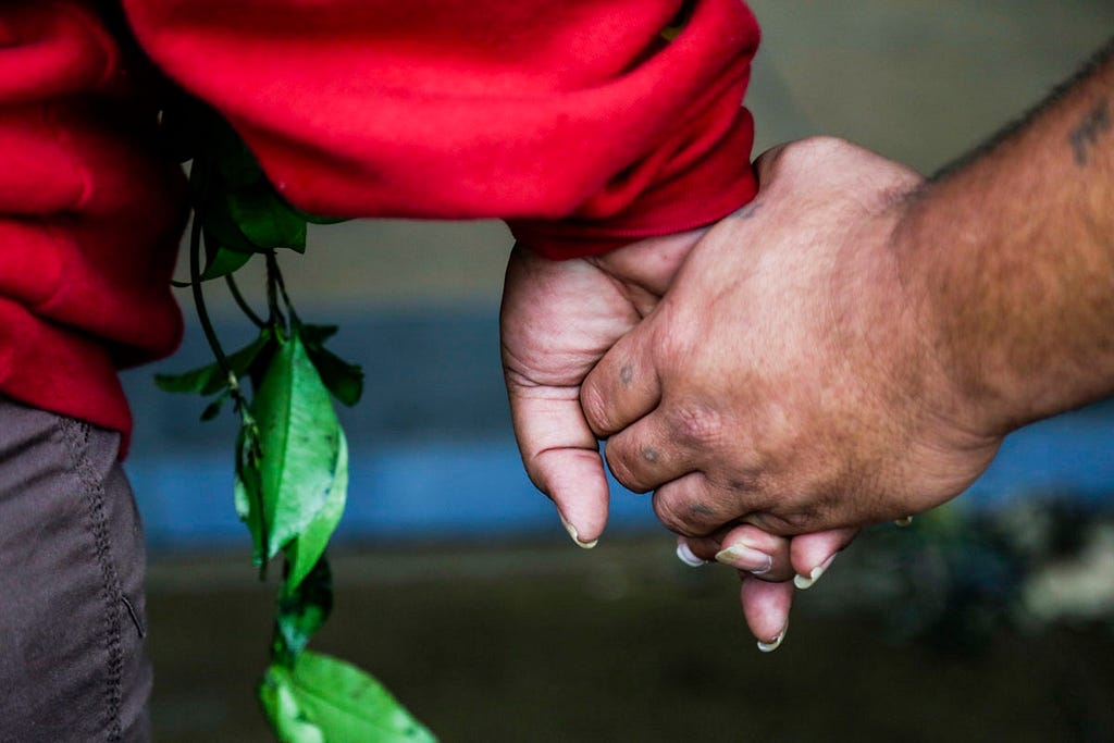 Two people holding hands.