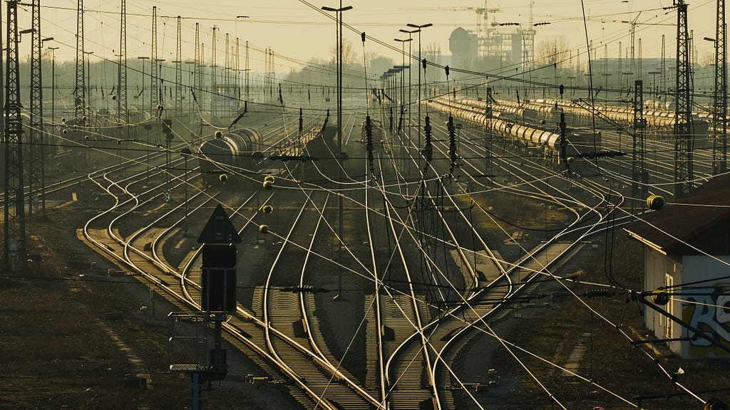 Branching train tracks and electricity wires