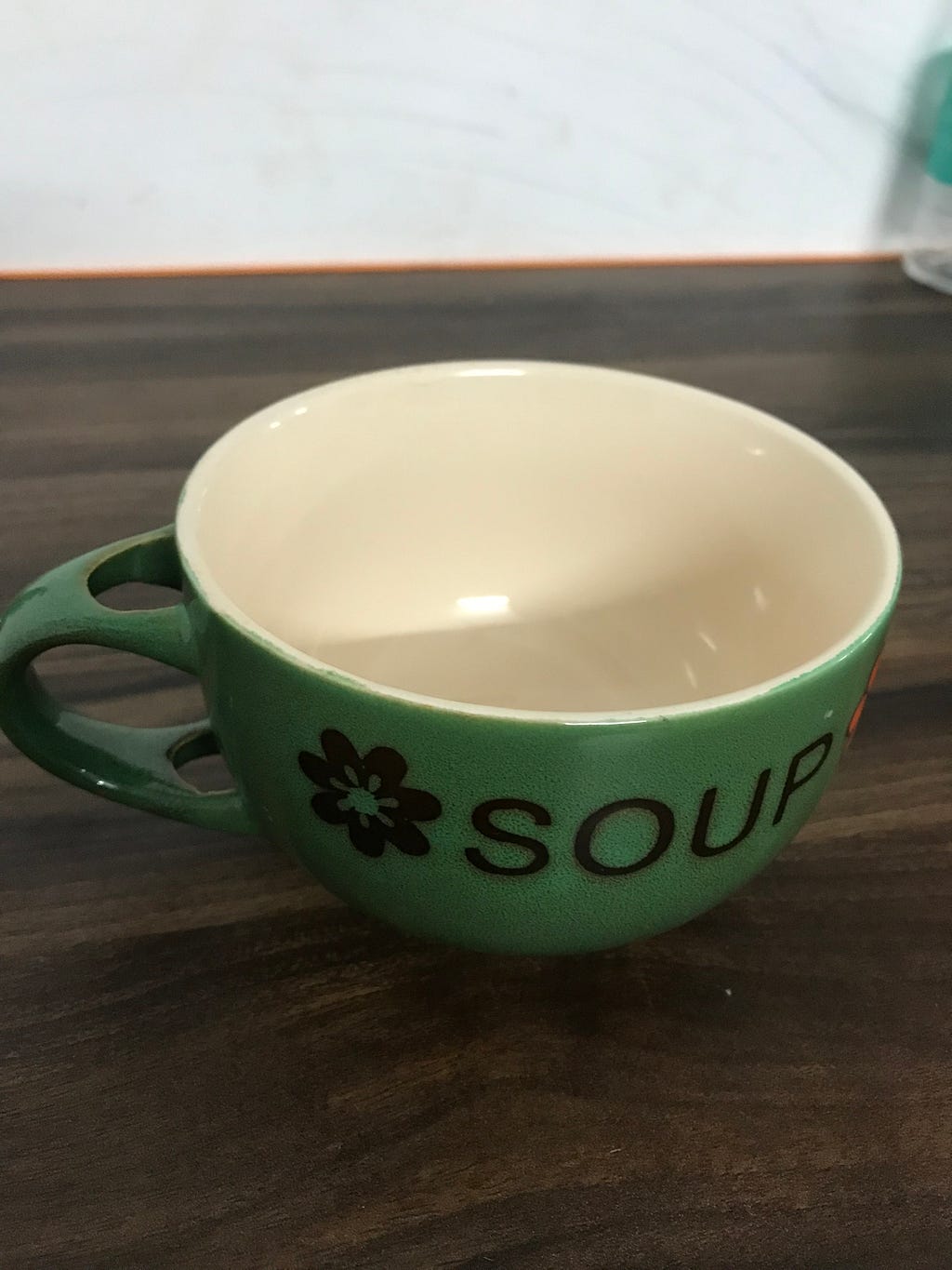 A bowl with a side handle to hold it as a cup.