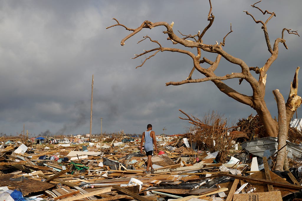 A man walks among debris at the Mudd neighborhood after Hurricane Dorian hit the Abaco Islands, Bahamas, September 6, 2019