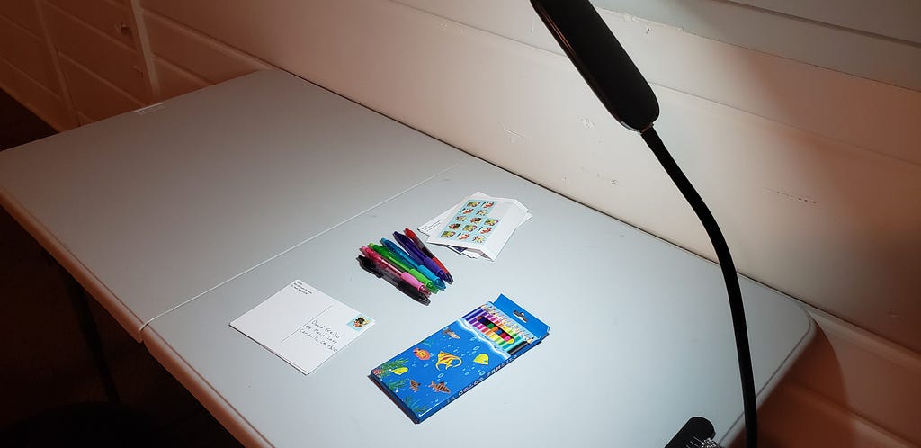 A desk with art supplies and reading light.