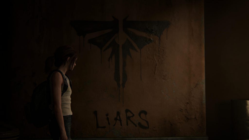 Ellie stands looking at a wall with the Firefly logo and the word LIARS painted underneath.