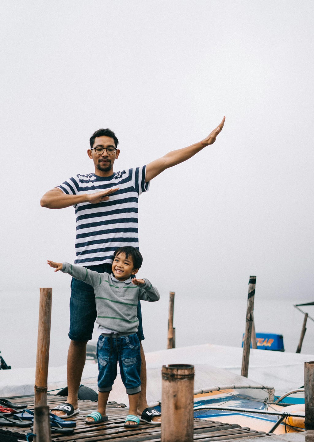 Photo of a man and his son on a boardwalk