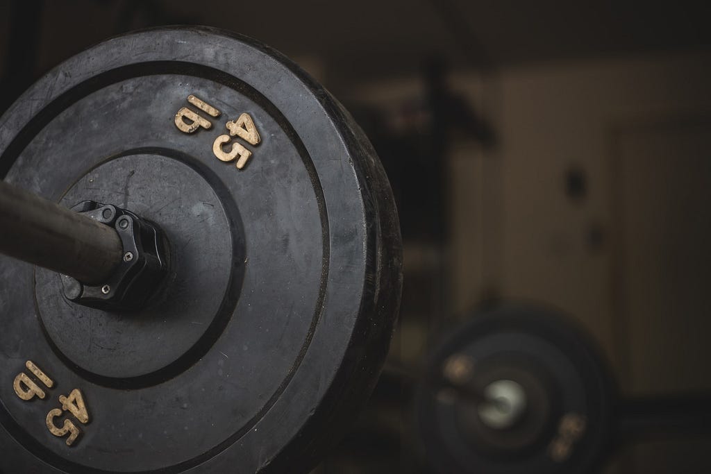 Barbell with multiple 45lb plates on each side.