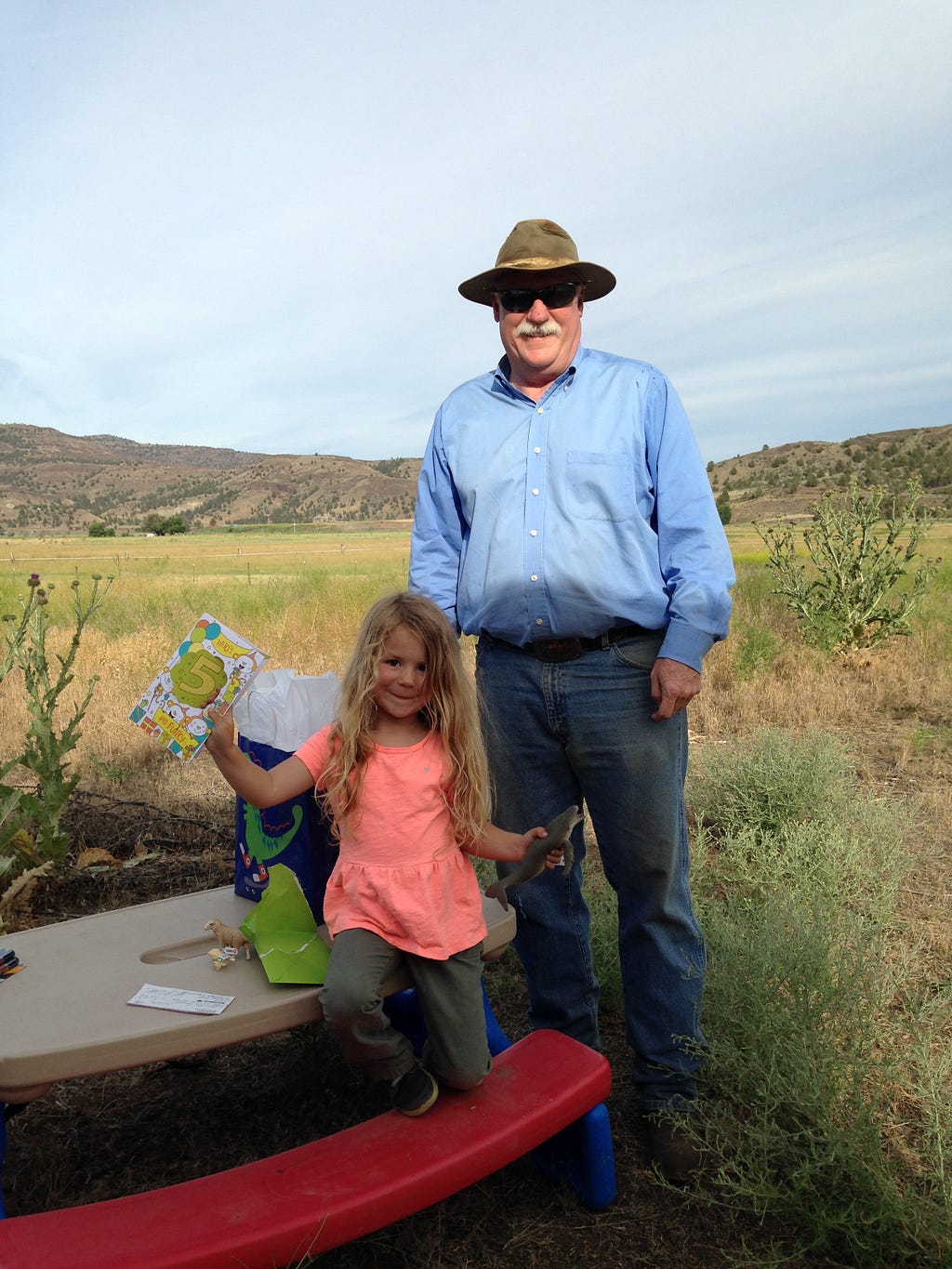 Olivia celebrating her 5th birthday with her Grandpa Kevin at the ranch in Spray.