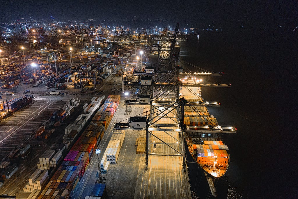 a photo of a port at night to represent the supply chain