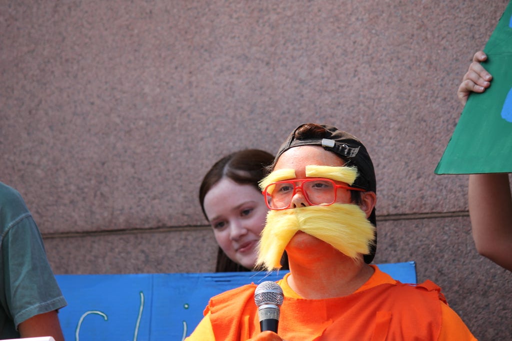 Cincinnati student, dressed as the Lorax, speaks to the crowd at Cincinnati’s climate strike.