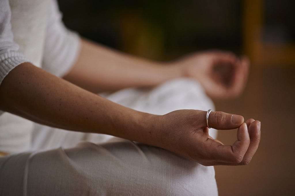 torso of a person sitting in meditation