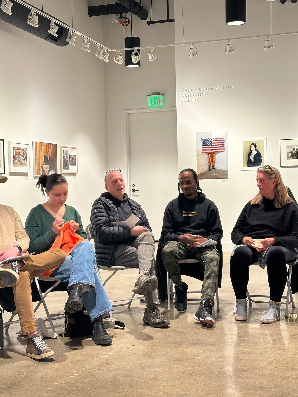 Four people sit in a semi circle listening and talking.
