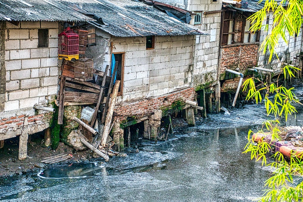 Broken Houses near Polluted River