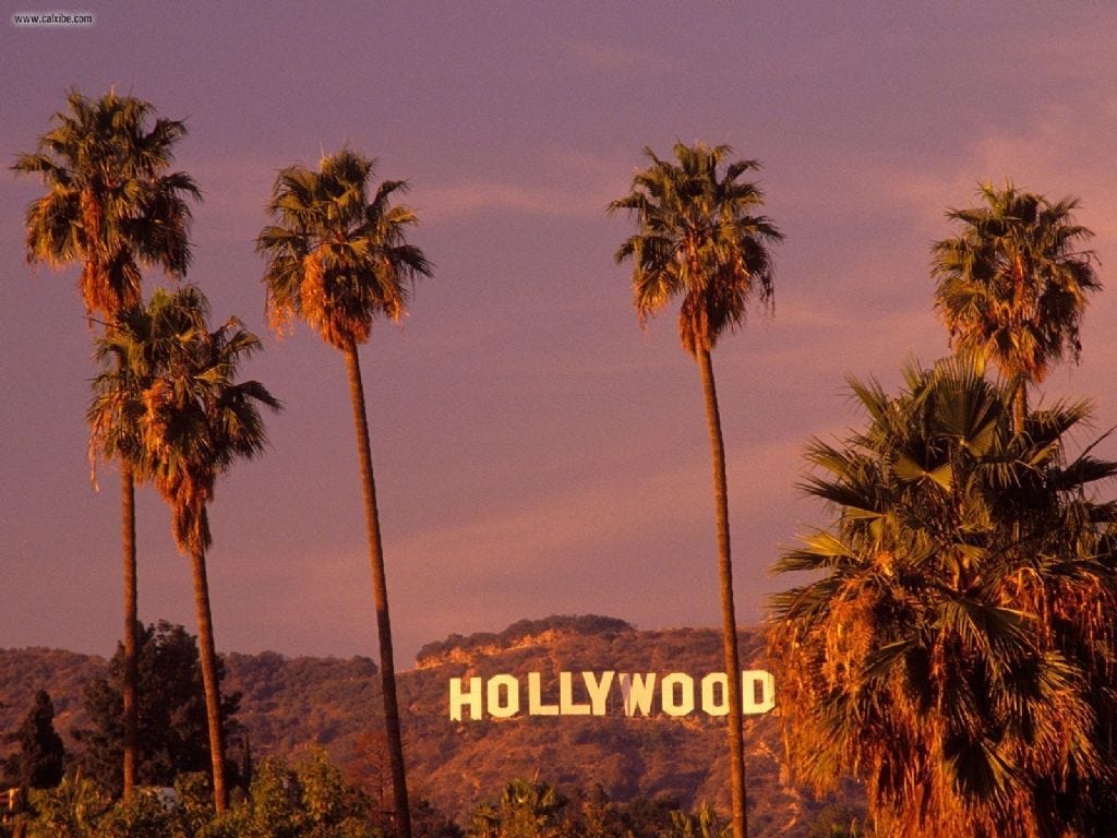 The Hollywood sign with palm trees in the foreground