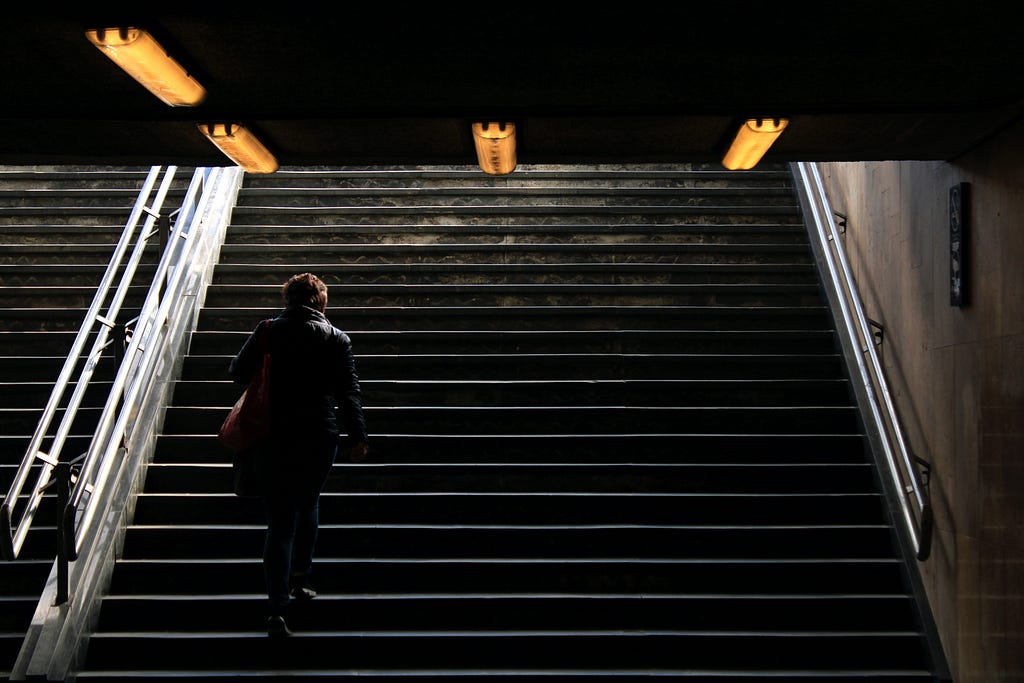 an employee going up subway stairs after leaving work