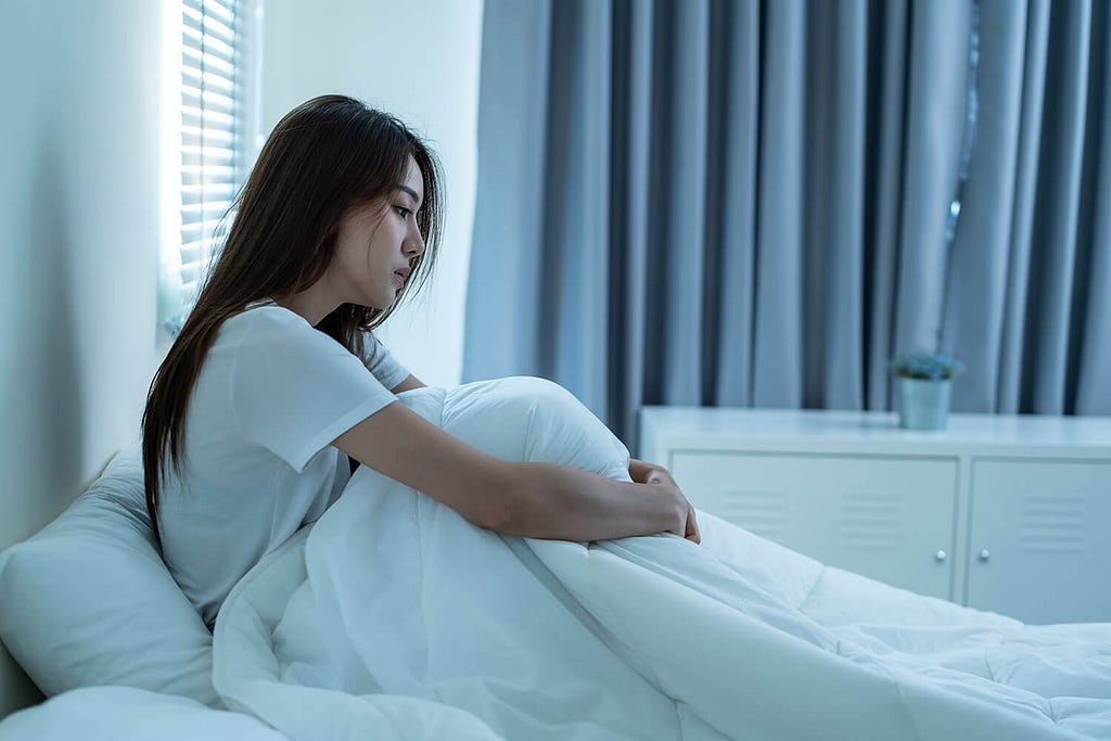 girl who failied sitting upset in bed