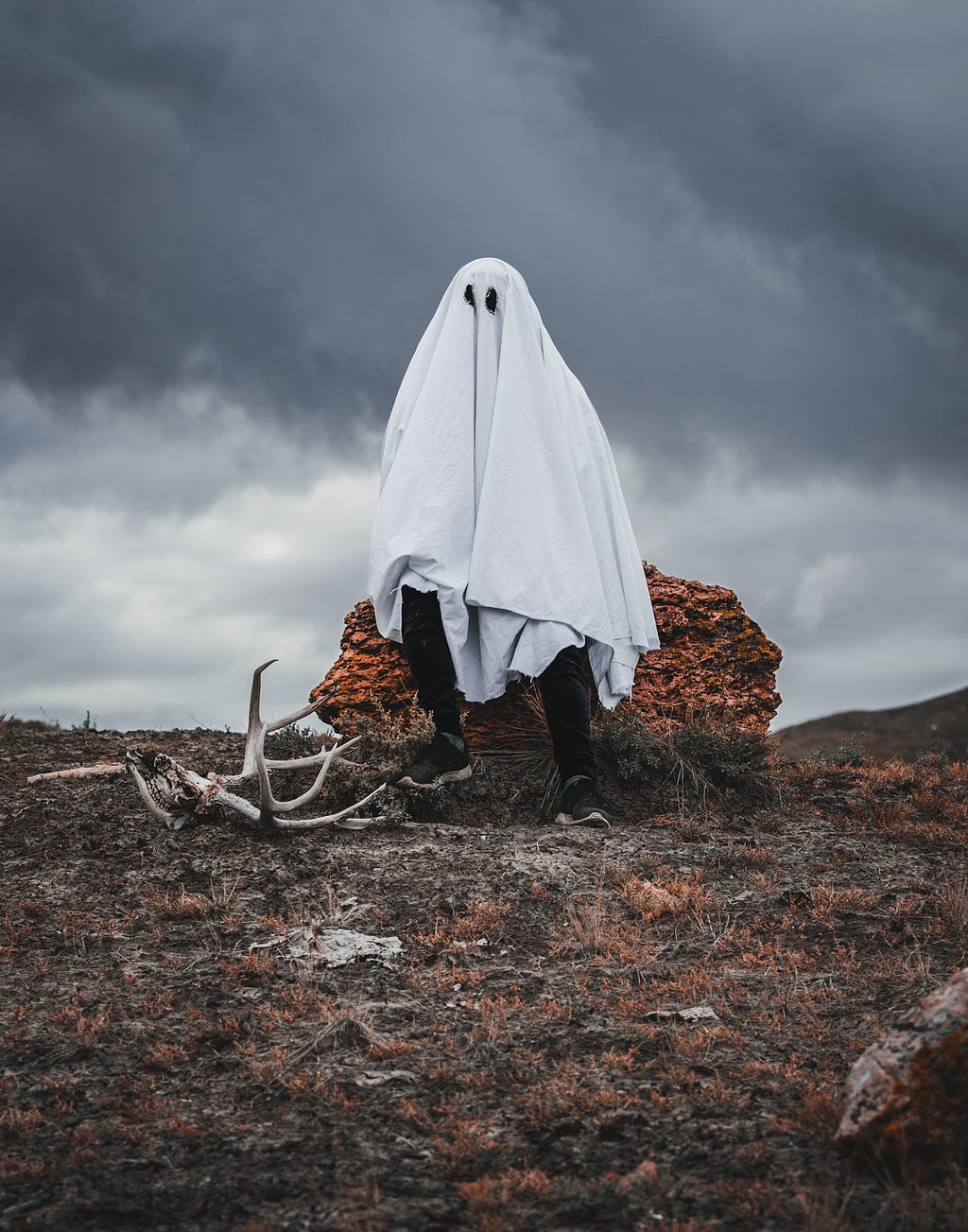 A man wearing a white robe to create an illusion of a ghost