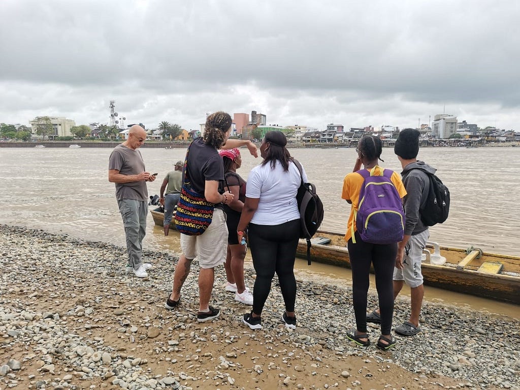 A group of Change the Story research participants stand by a river