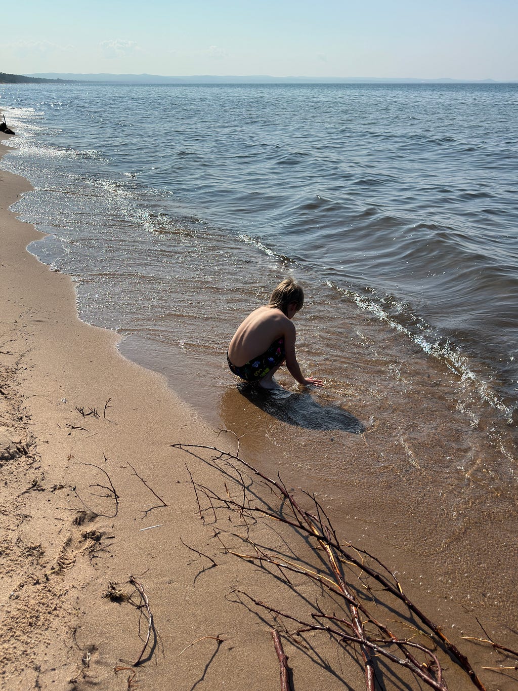 small boy playing on the beach of Lake Superior — Marquette