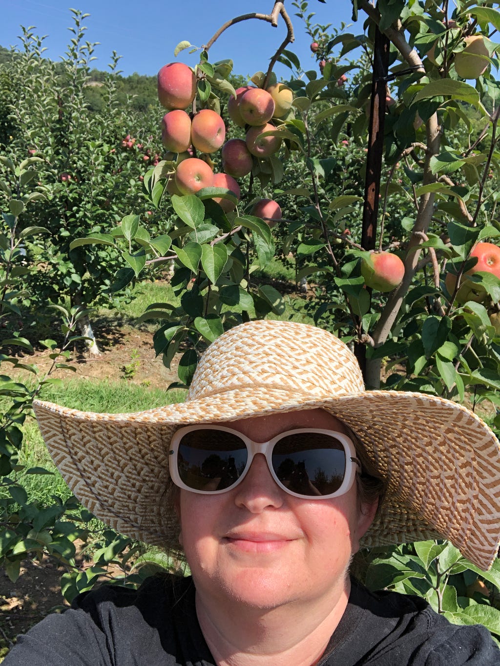 The author standing in front of her favorite apple tree.