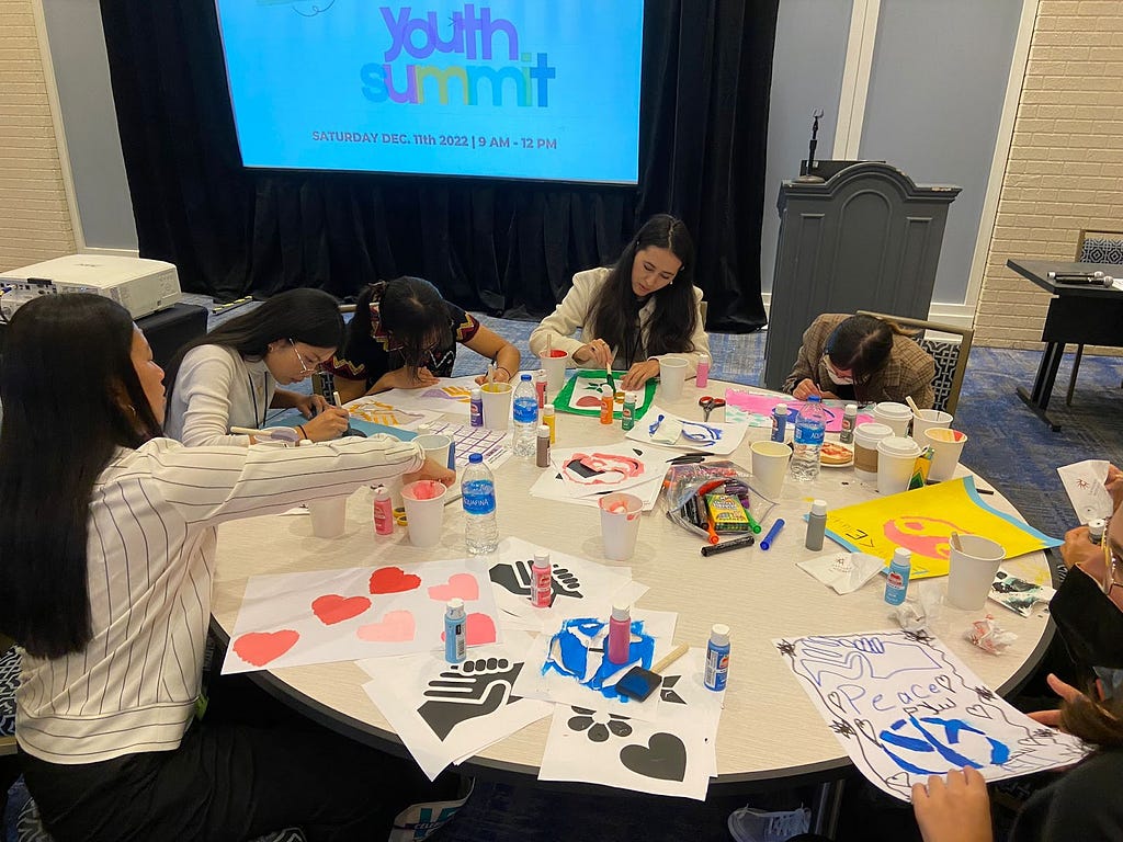 NAYLC Youth Leadership Summit Participants making posters at the National Immigrant Inclusion Conference (NIIC) 2022