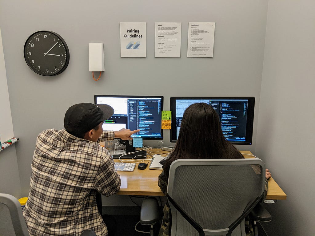 Two of our engineers talking through some code during a pairing session