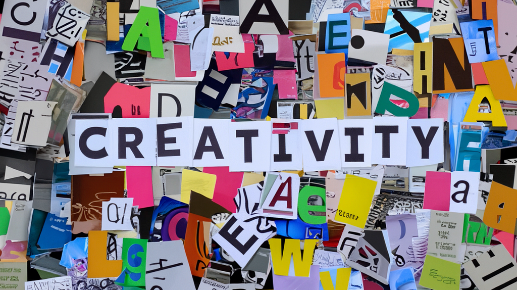 Colorful cutouts of letters compiled into a collage. On top of it are letters spelling out the word creativity.