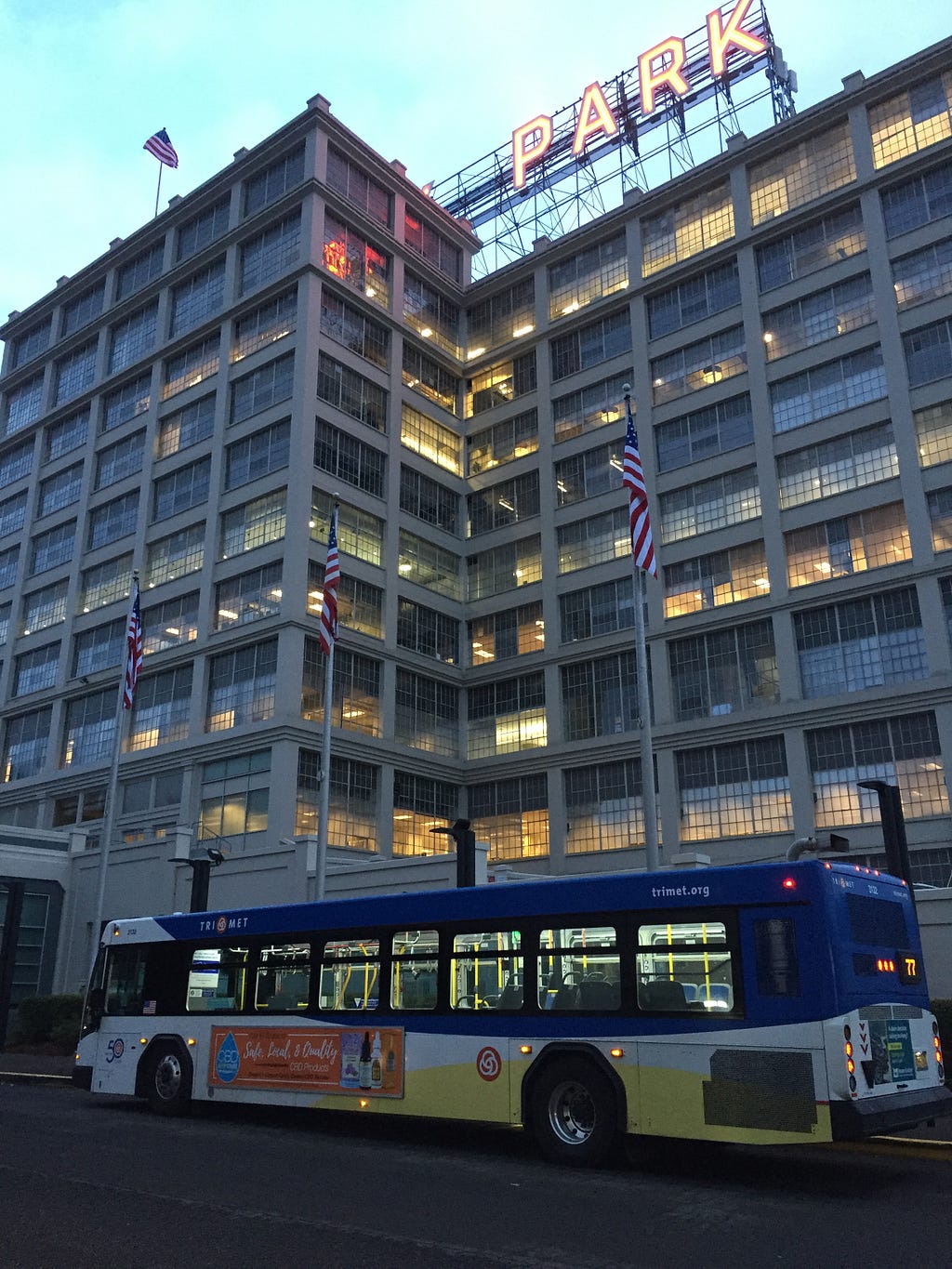 A picture of a TriMet Line 77 bus parked in front of Montgomery Park at Sunrise.