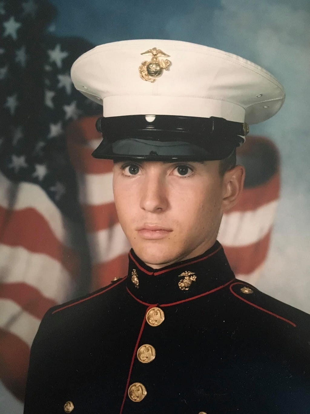 A young Riley is photographed in his Marine uniform.