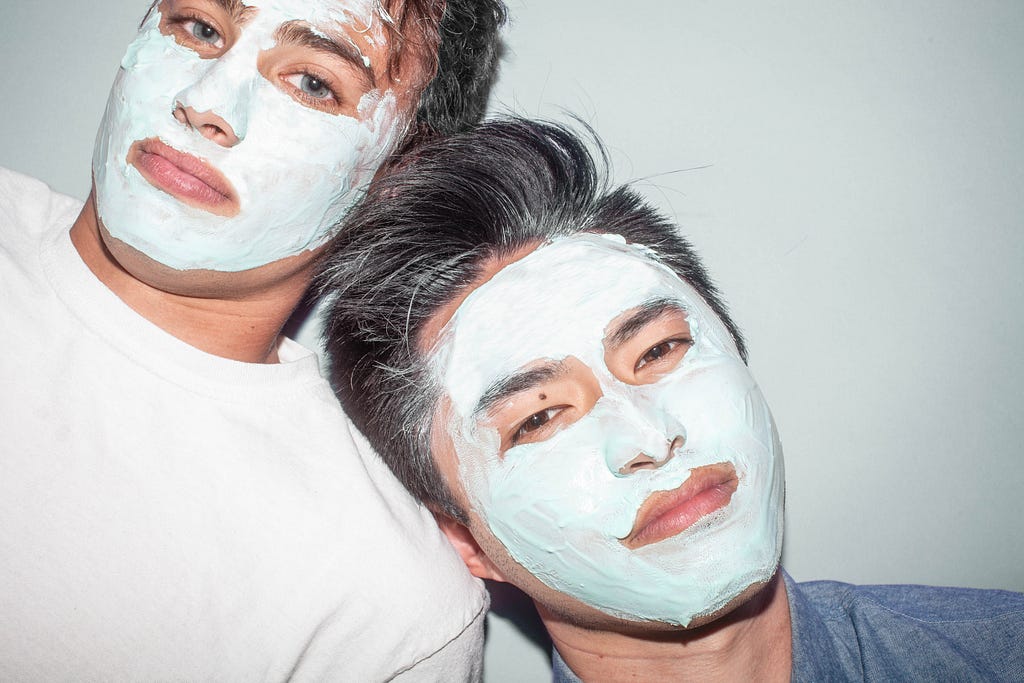 Two men with face masks on their skin.