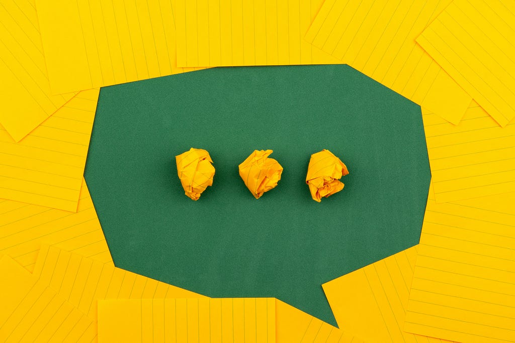 A speech bubble made out of yellow and green paper
