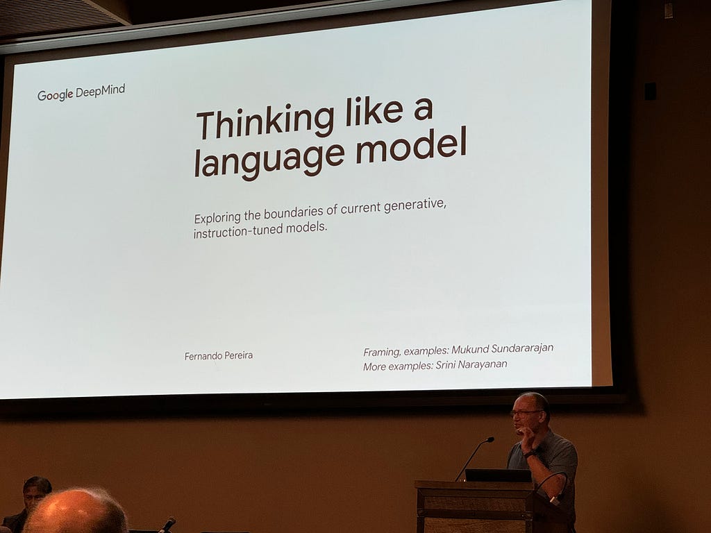 Fernando, a bald white man with a blue short sleeve polo shirt, in front of a white slide that says “Thinking like a language model”