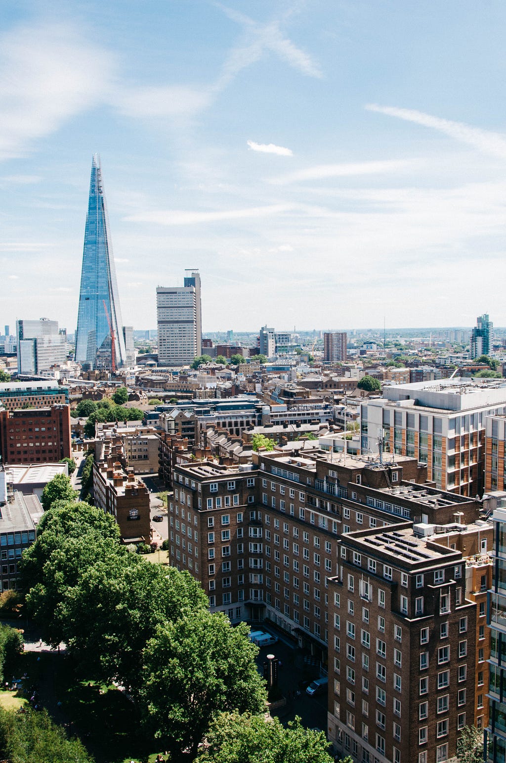 An image of London showing residential and commercial buildings against a clear blue sky