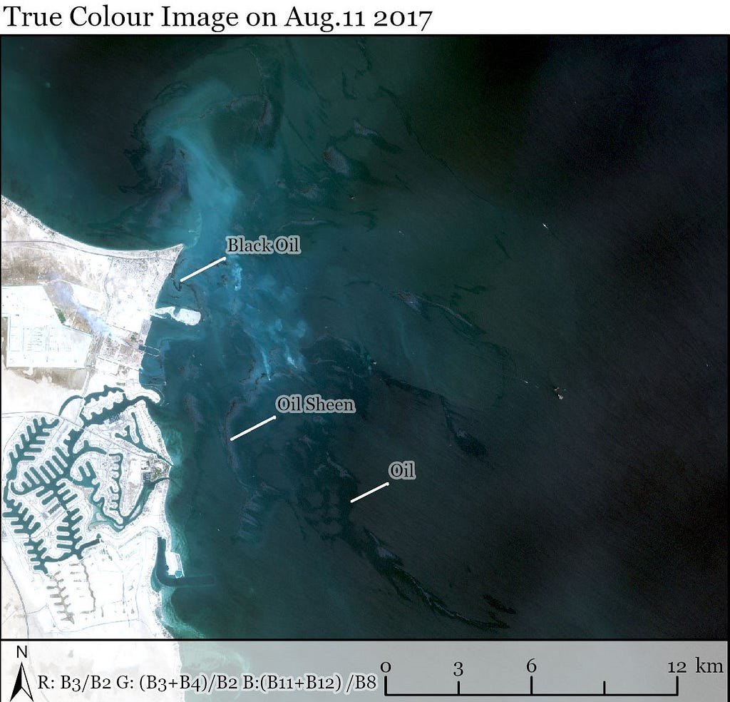 The image shows the coastal resort community of Al Khain. The oil appears darker than the water and oil sheens appear lighter than the water.