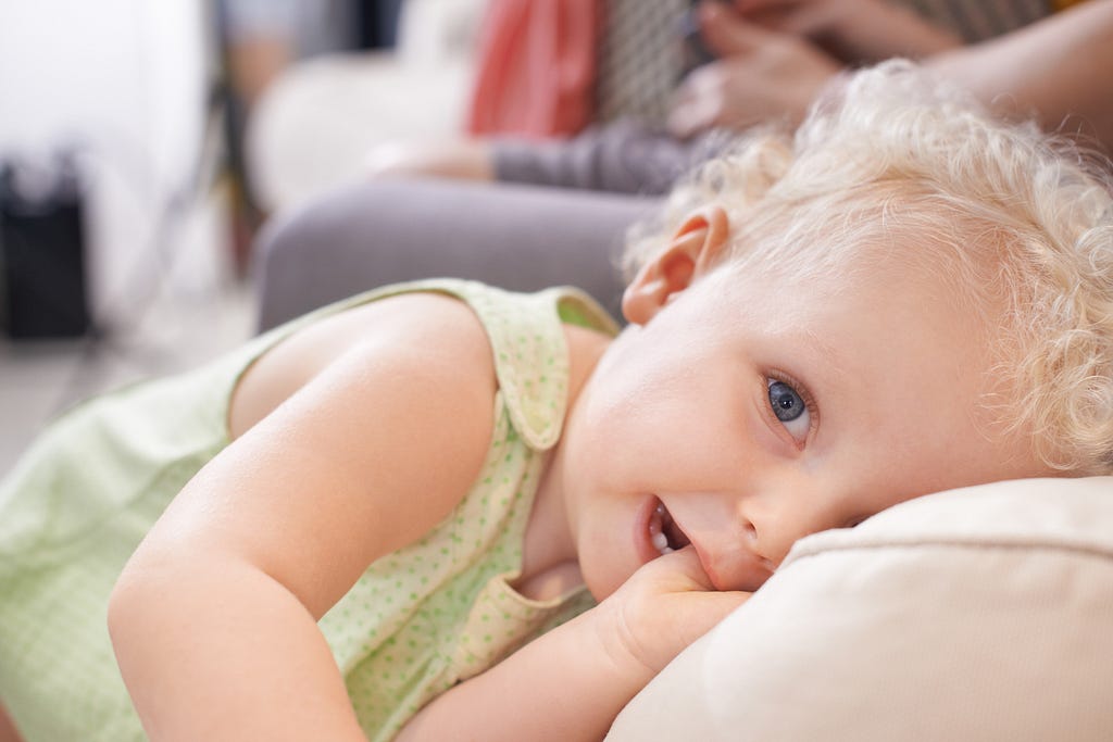 Portrait of an adorable young toddler with curly blonde hair, radiating cuteness and innocence.