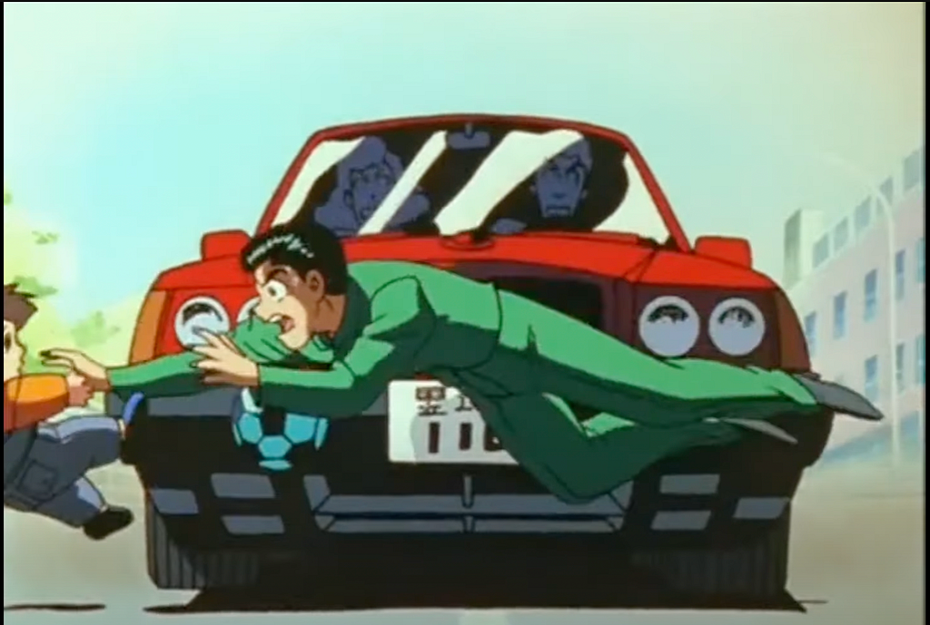 A screenshot from the anime, “Yu Yu Hakusho” where the title character is pushing a child out of the way of a car, getting hit himself.