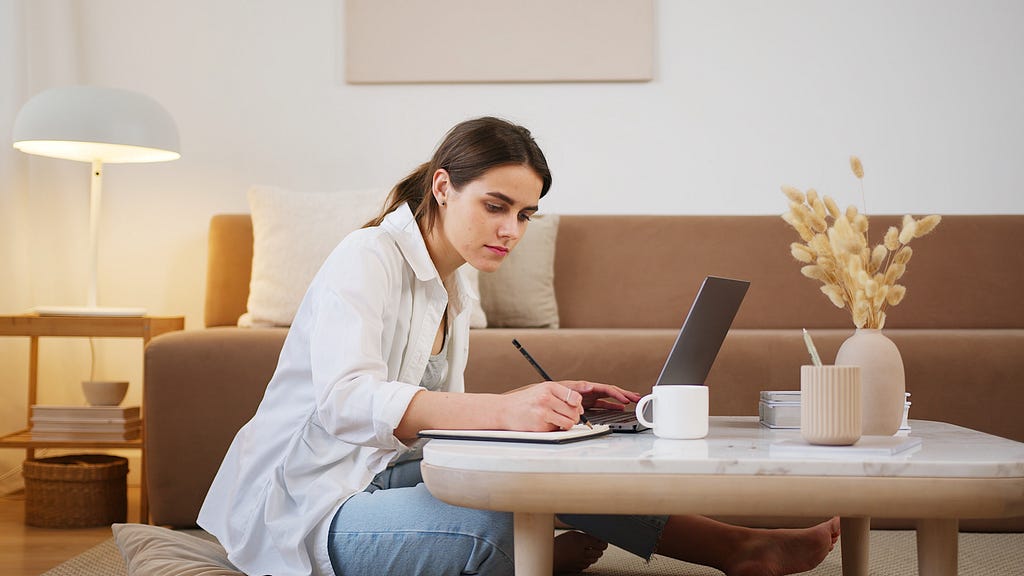 A girl is having online education on laptop, at her home.