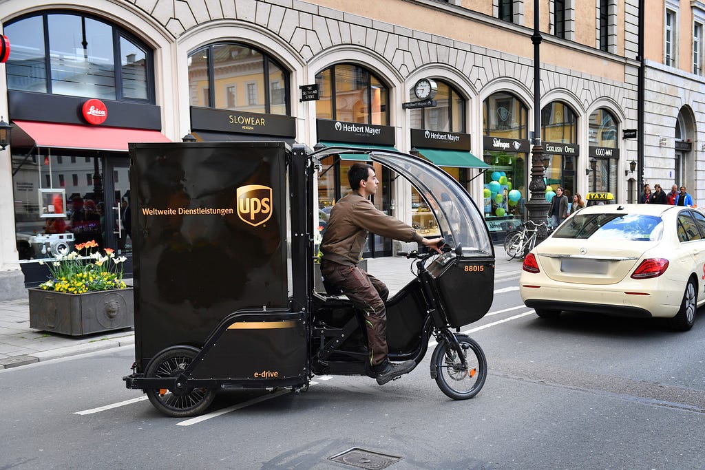 A photograph of a UPS electric delivery freight bike on the streets of Munich, Germany.