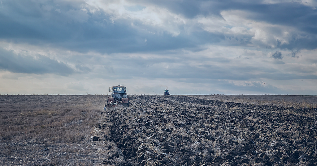 Picture of a farmer plowing a field with a tractor