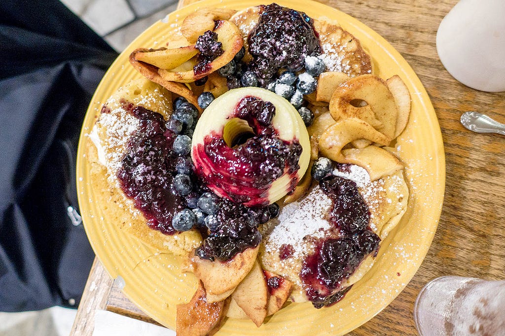 pumpkin pancakes and blueberries on a yellow plate