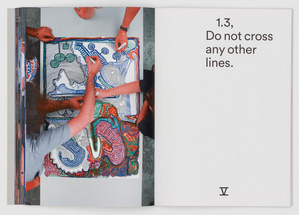 A page from a book. One side has a vibrant drawing by 4 people; the other has the instruction “Do not cross any other lines.”