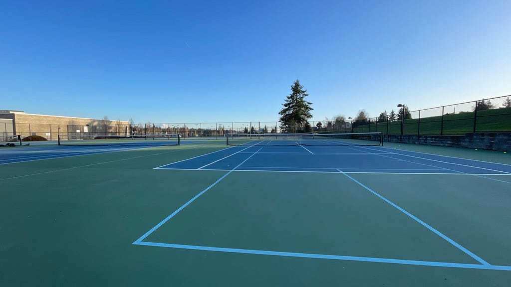 An empty tennis court on a sunny day